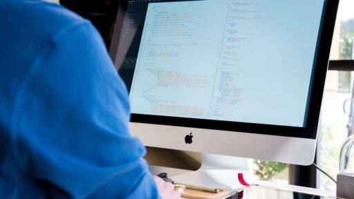 A man is working on a computer screen.