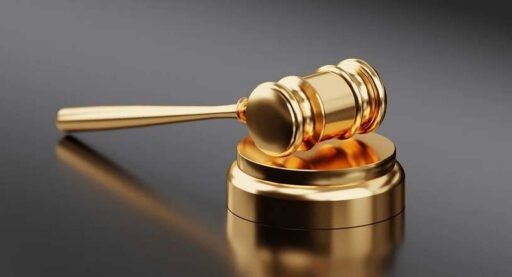 A gold gavel on a black background.
