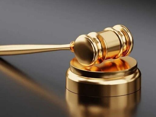 A gold gavel on a black background.