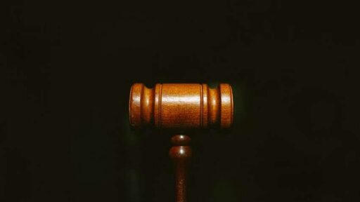 A wooden gavel on a black background.